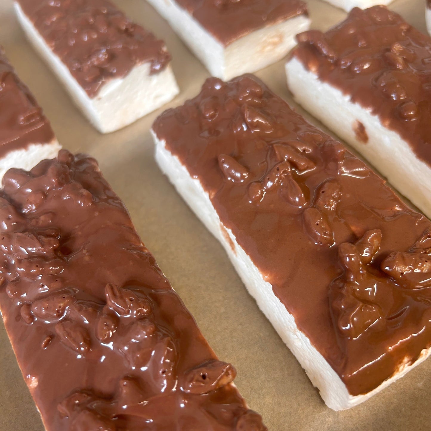 Toffee Crunch Protein Marshmallow Bar coated in milk chocolate with crunchy rice snaps, handmade in the UK by Trim Treats.