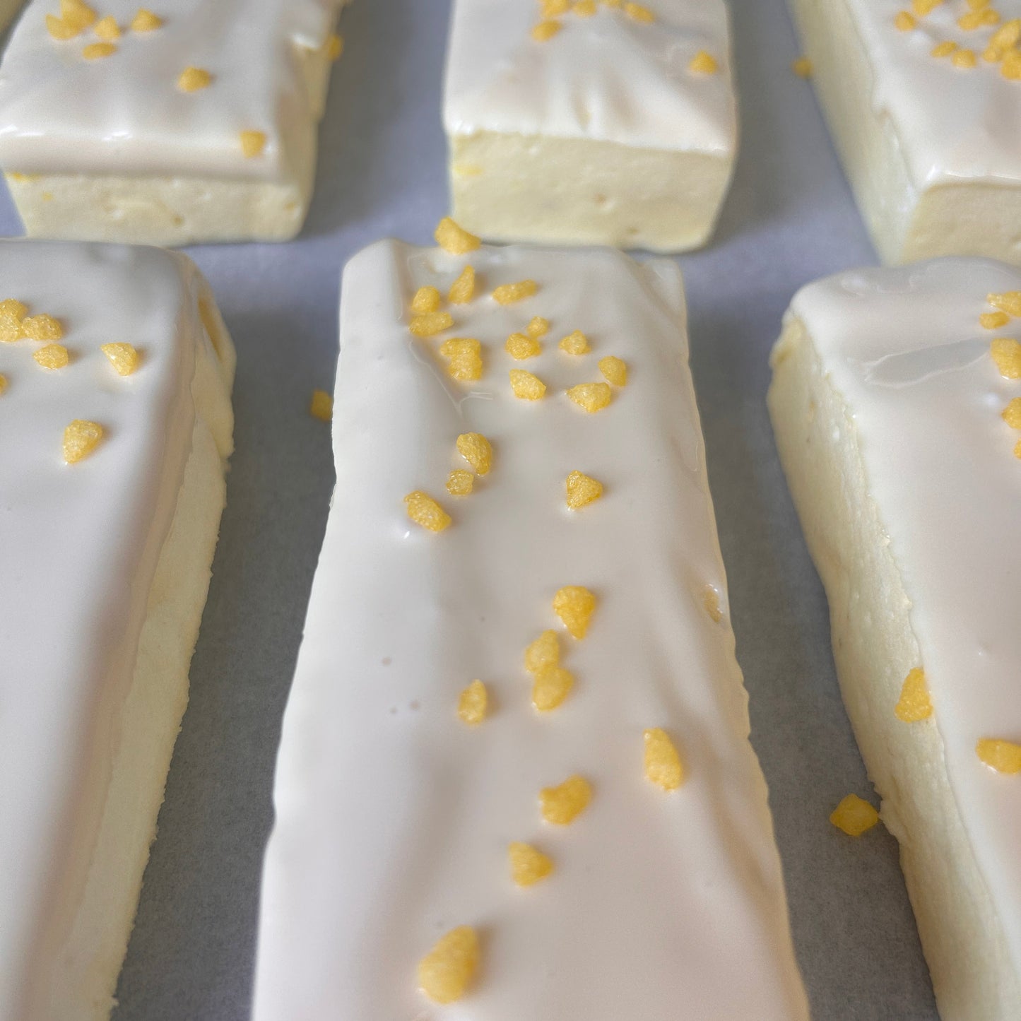 Low calorie raspberry and white chocolate protein marshmallow bars coated in white chocolate.