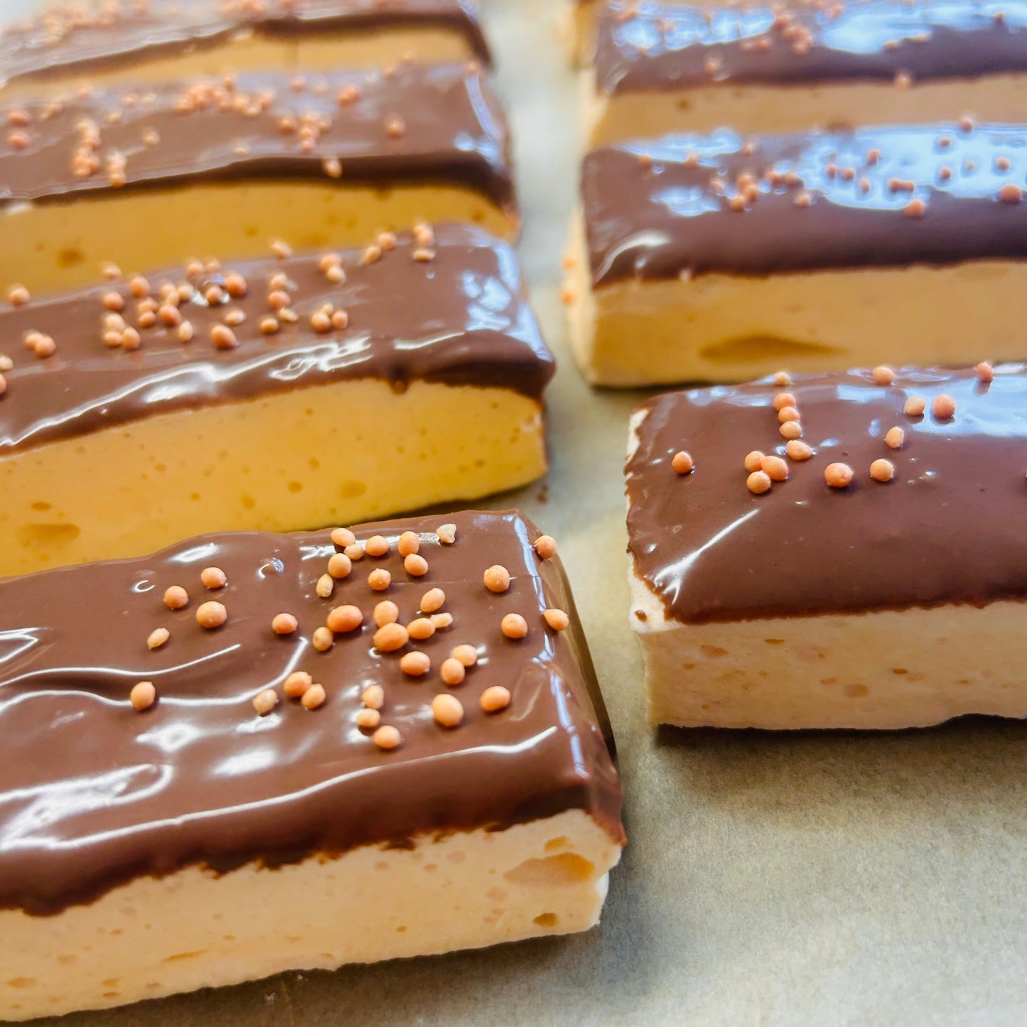 Orange Protein Marshmallow Bar coated in milk chocolate, handmade in the UK by Trim Treats.
