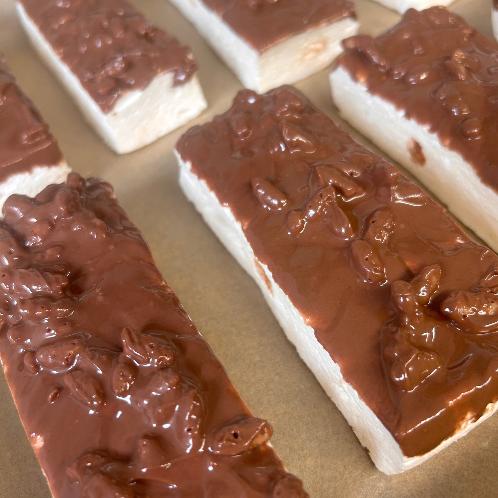 Toffee Crunch Protein Marshmallow Bar coated in milk chocolate with crunchy rice snaps, handmade in the UK by Trim Treats.