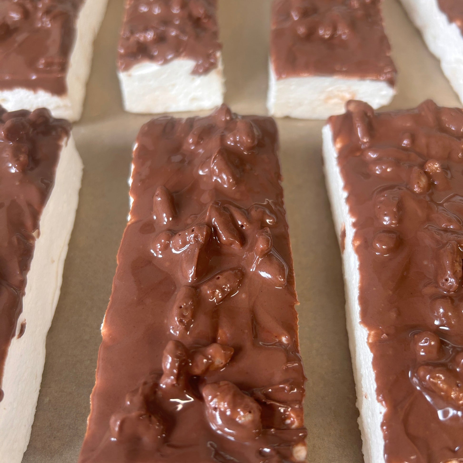 Toffee Crunch Protein Marshmallow Bar coated in milk chocolate with crunchy rice snaps, handmade in the UK by Trim Treats.